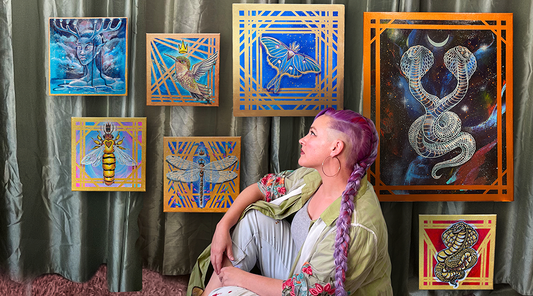 Krisztianna sitting in front of her acrylic paintings for her solo show Luxe Matronae
